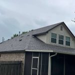 House roof with gutter system and gray shingles in Austin TX.